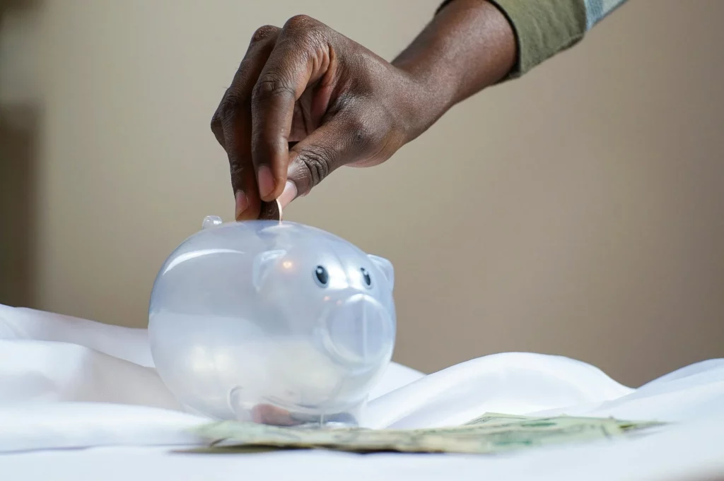 Woman putting money in piggy bank