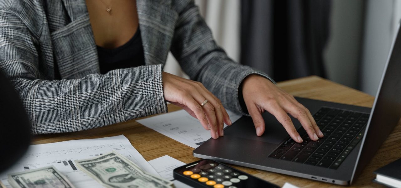 Woman investing from laptop